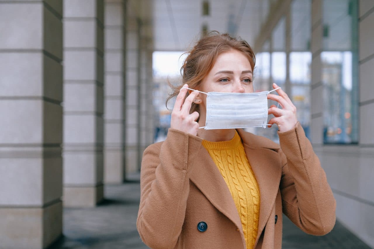 Woman putting a face mask on