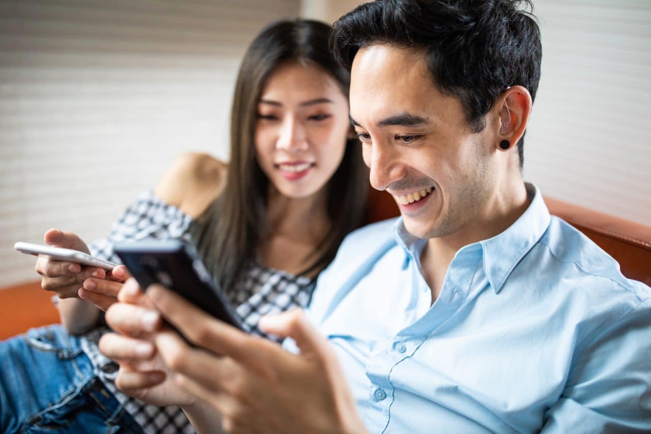 Man with hearing aids relaxes with his partner.