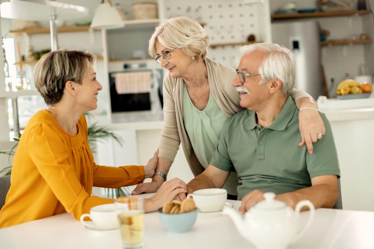 Adult daughter talking with her parents.