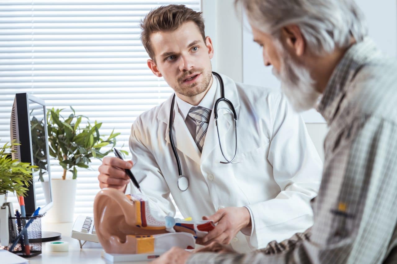 Audiologist discussing hearing loss with a patient.