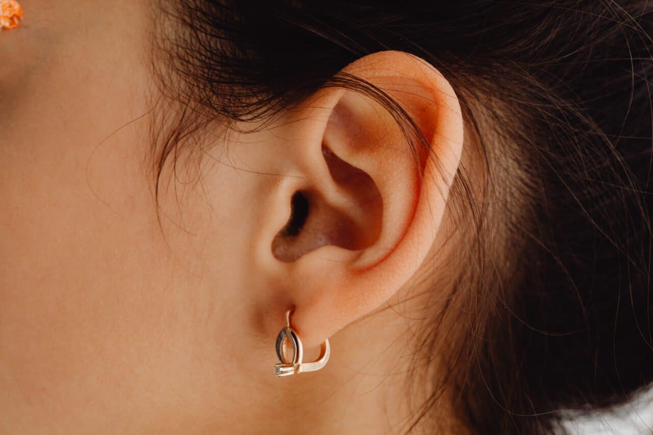 Close-up of a woman with a pierced earlobe.