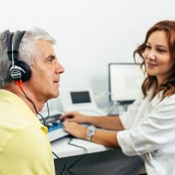 Man taking a hearing test at the audiologist