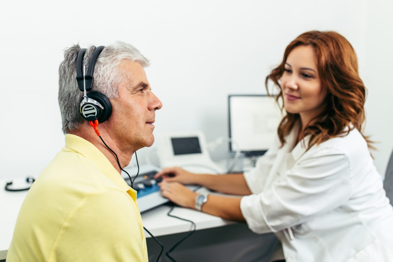 Man taking a hearing test at the audiologist.