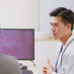 Provider explaining shingles to his patient, image of a shingles rash on his computer