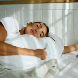 Young woman sleeping in bed