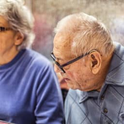 man with hearing loss tilting head to listen